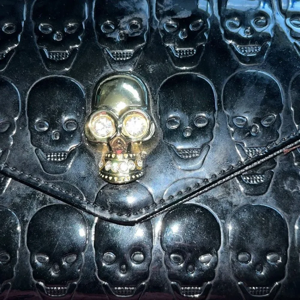 Awesome patent leather skull embossed clutch bag with gold chain shoulder strap.